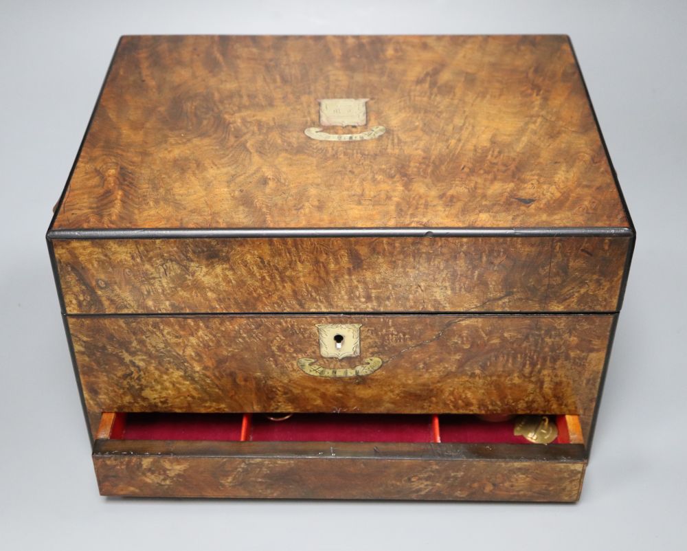 A walnut toilet box, containing four bottles and assorted badges and jewellery etc.